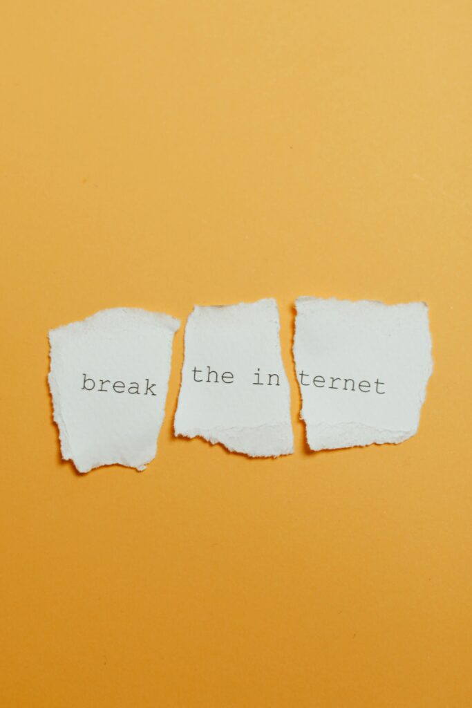 Conceptual image of torn paper with text 'break the internet' on yellow background.