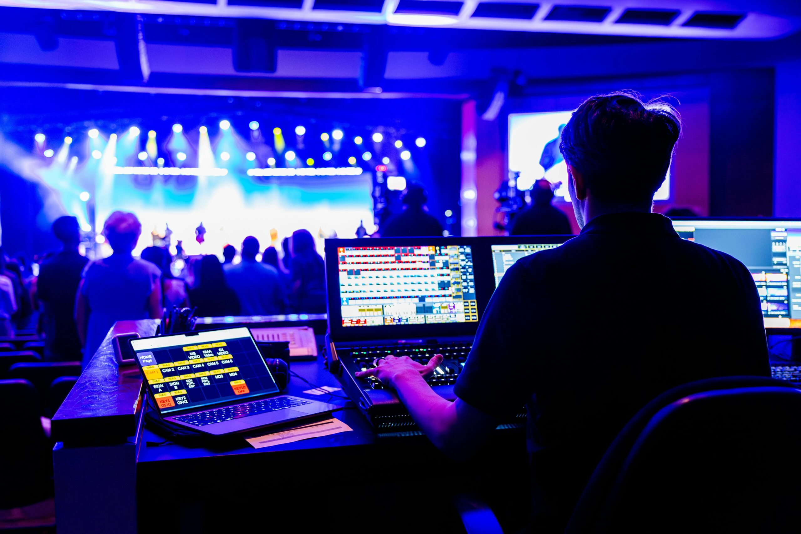 Professional technician managing lighting and sound at a live concert, showcasing modern technical skills.